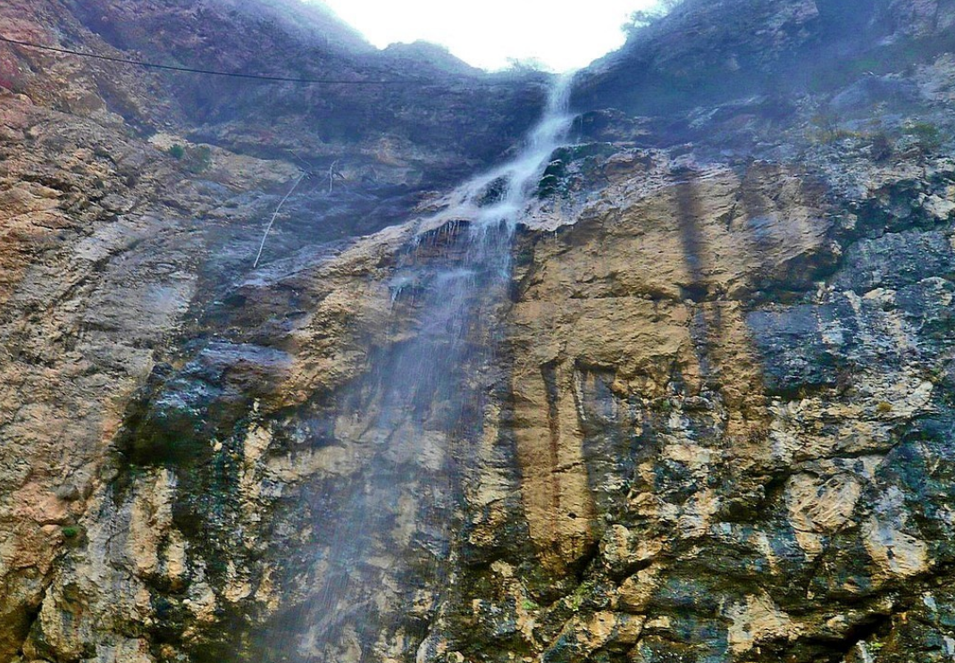 Afurja waterfall amidst lush forest landscape